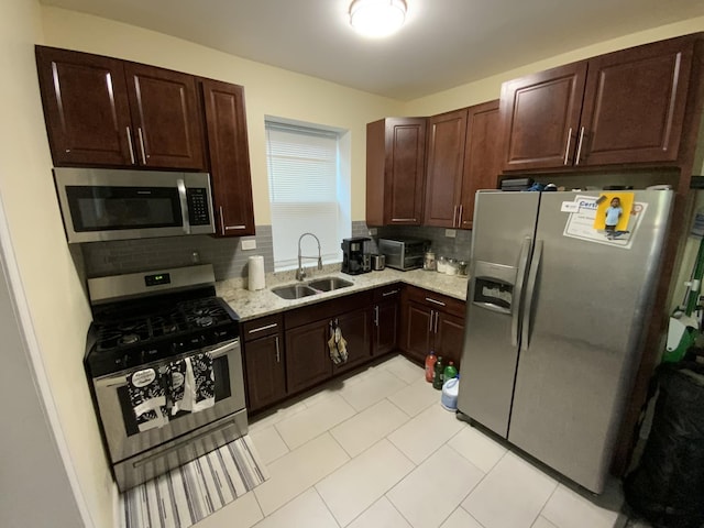 6639 S Rhodes Ave, Chicago, IL 60637 - kitchen with appliances with stainless steel finishes, tasteful backsplash, dark brown cabinets, and light tile patterned floors