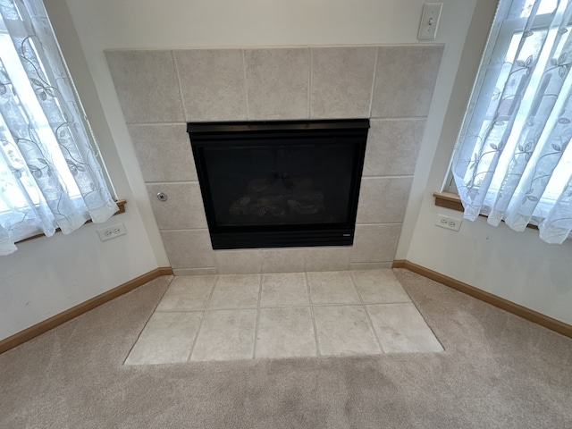 room details with carpet floors and a tiled fireplace