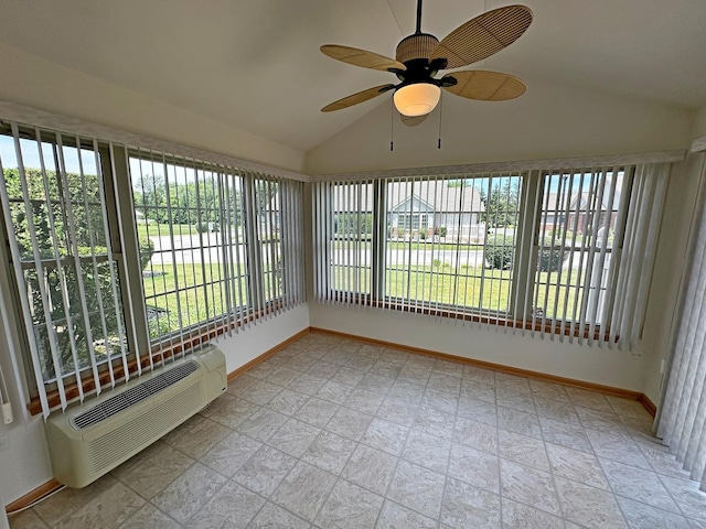 unfurnished sunroom with ceiling fan, a wall mounted AC, and vaulted ceiling