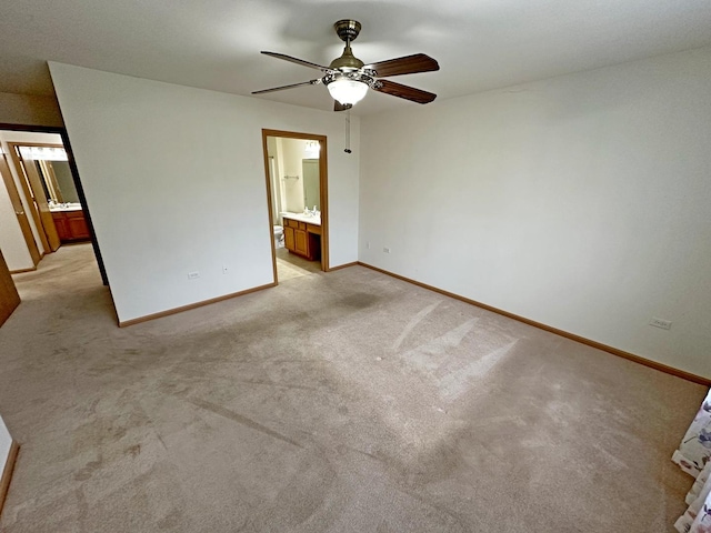 unfurnished bedroom with light carpet, ensuite bathroom, and ceiling fan