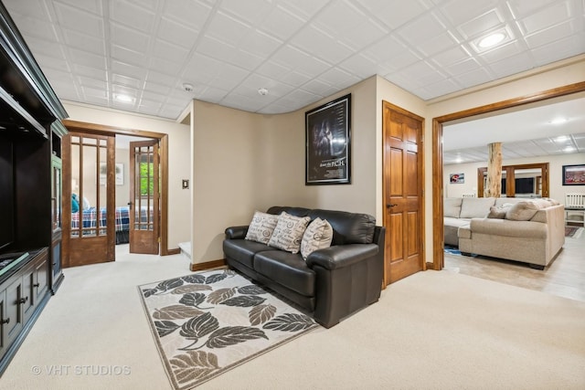 carpeted living room with ornate columns