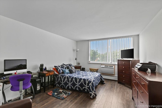 bedroom featuring dark wood-type flooring, a wall mounted AC, and a baseboard heating unit