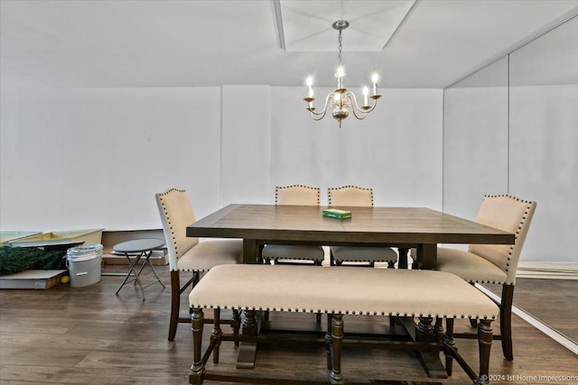 dining area with dark hardwood / wood-style flooring and an inviting chandelier