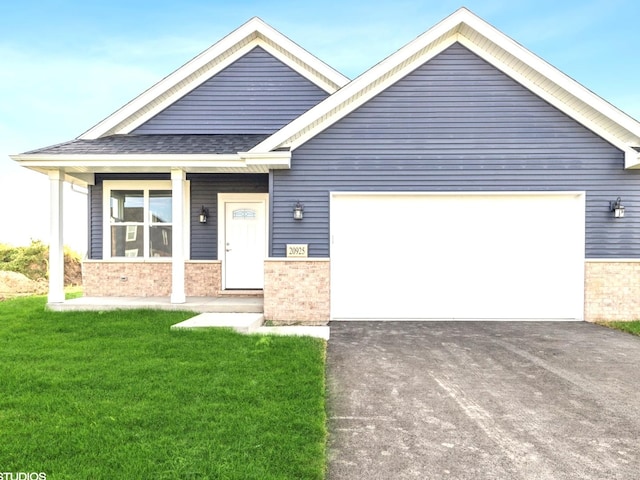 view of front of home with a garage, a front lawn, and a porch