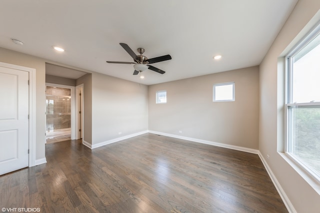 spare room with ceiling fan, dark hardwood / wood-style floors, and plenty of natural light