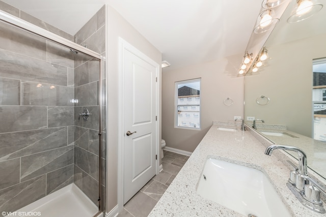 bathroom with walk in shower, dual vanity, tile patterned floors, and toilet