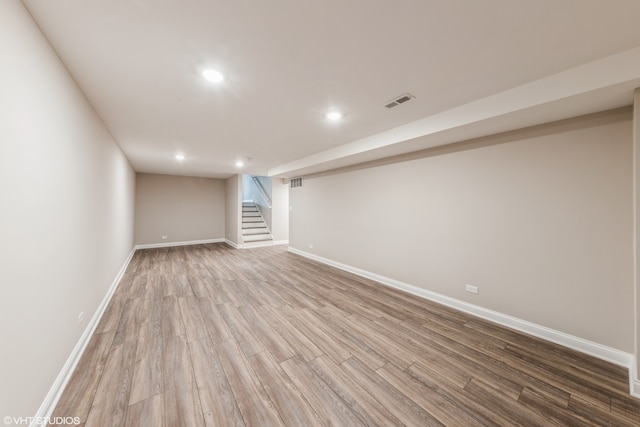 basement with hardwood / wood-style flooring