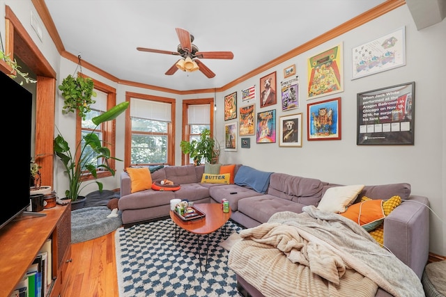 living room featuring ceiling fan, ornamental molding, and hardwood / wood-style flooring