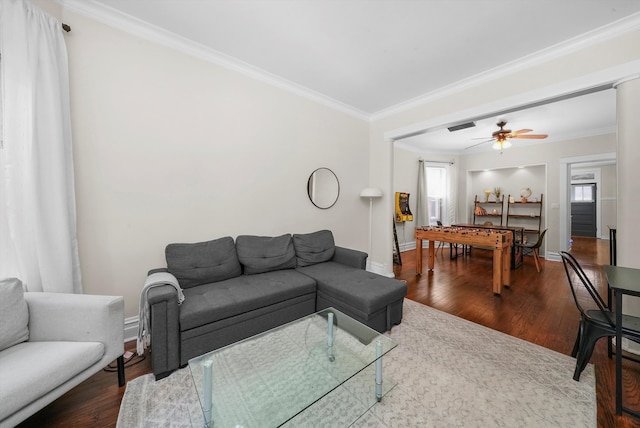 living room featuring ceiling fan, wood-type flooring, and ornamental molding