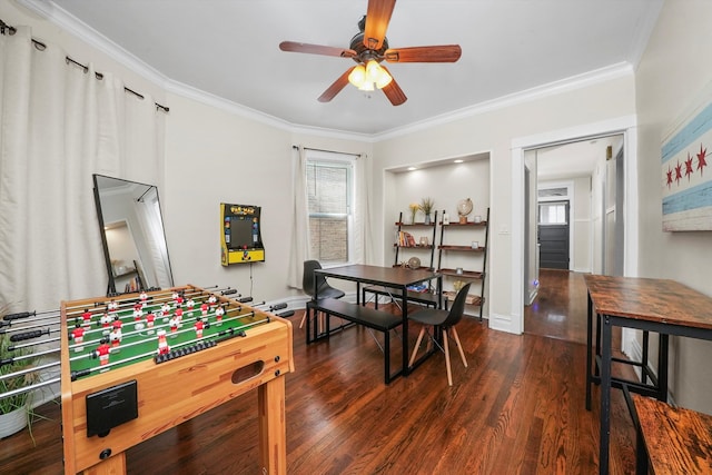 rec room featuring ceiling fan, dark wood-type flooring, and ornamental molding