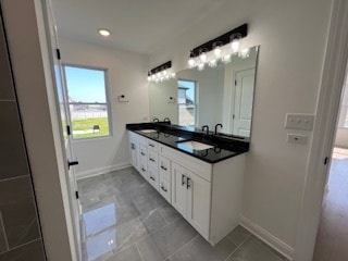 bathroom featuring double vanity and tile patterned floors