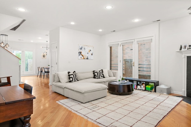 living room featuring light wood-type flooring and french doors