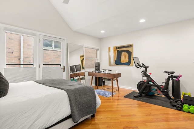 bedroom with lofted ceiling and light hardwood / wood-style flooring