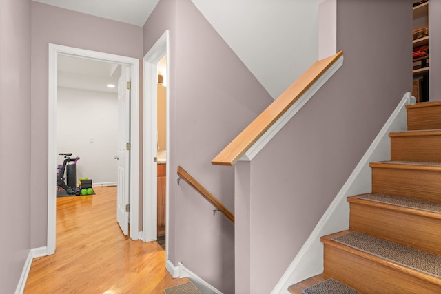 staircase featuring light hardwood / wood-style floors