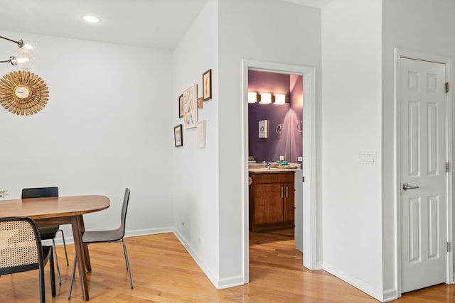 dining area featuring sink and light wood-type flooring