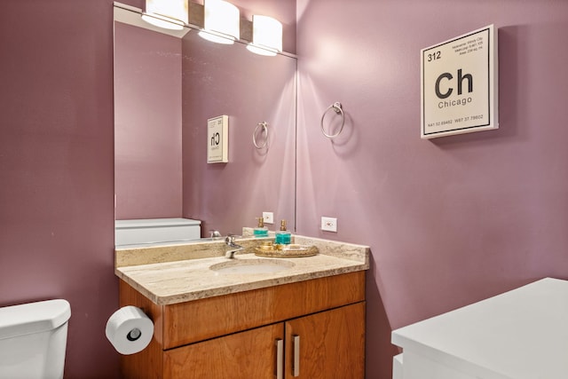 bathroom featuring vanity and toilet