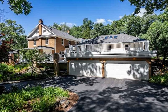 view of front of home with a balcony and a garage