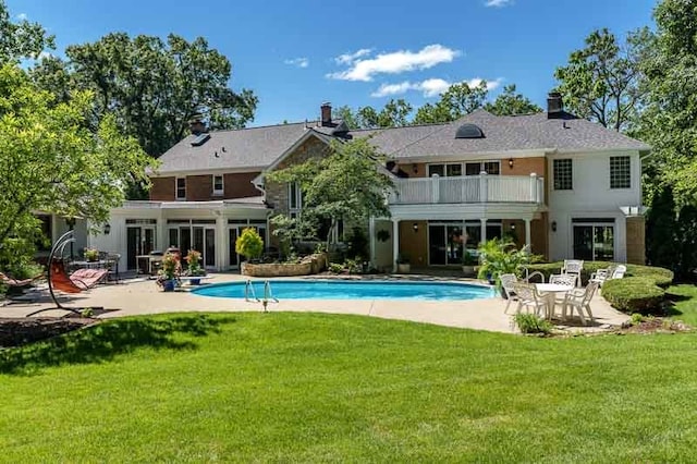 view of pool with a lawn and a patio area