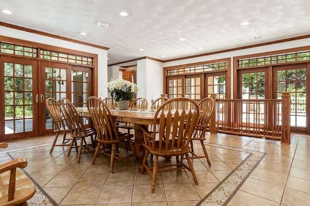 tiled dining area with ornamental molding, a wealth of natural light, and french doors