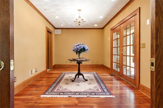 office featuring ornamental molding, an inviting chandelier, hardwood / wood-style flooring, and french doors