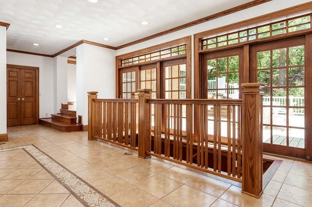 interior space featuring crown molding and light tile patterned floors