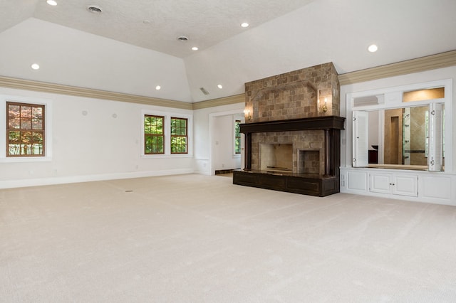 unfurnished living room with carpet flooring, a fireplace, crown molding, and vaulted ceiling