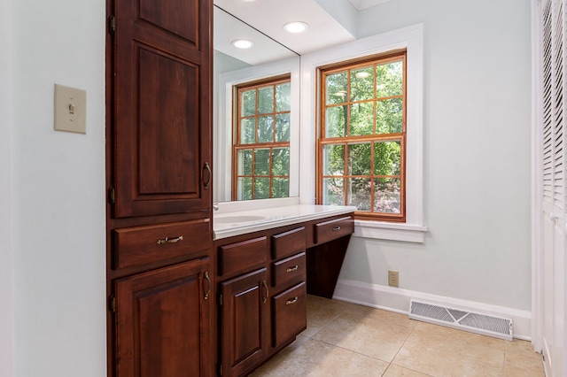 bathroom with tile patterned flooring and vanity