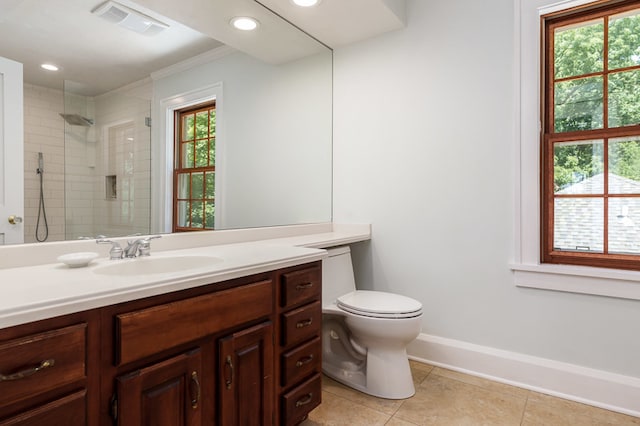 bathroom featuring tile patterned floors, vanity, toilet, and a wealth of natural light