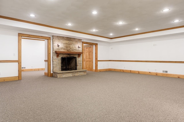 unfurnished living room featuring a fireplace, crown molding, and carpet floors