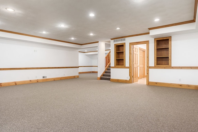 basement featuring crown molding, carpet flooring, and built in features