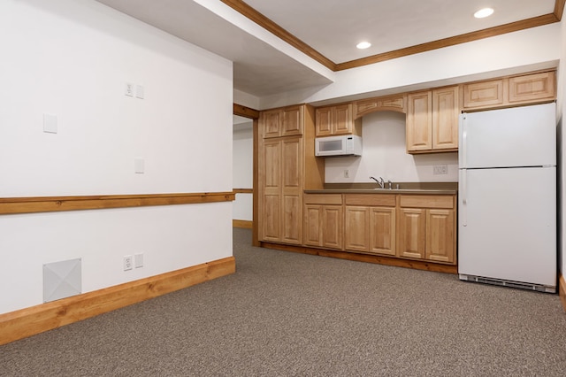 kitchen with sink, carpet flooring, crown molding, and white appliances