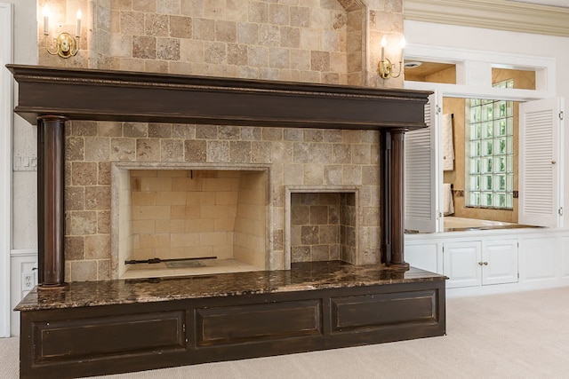 interior details with crown molding, a fireplace, and carpet