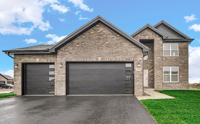 view of front of property with a garage and a front lawn