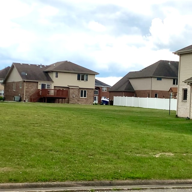 view of yard with a wooden deck and central AC unit