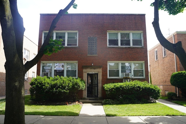 view of front of home with cooling unit and a front lawn