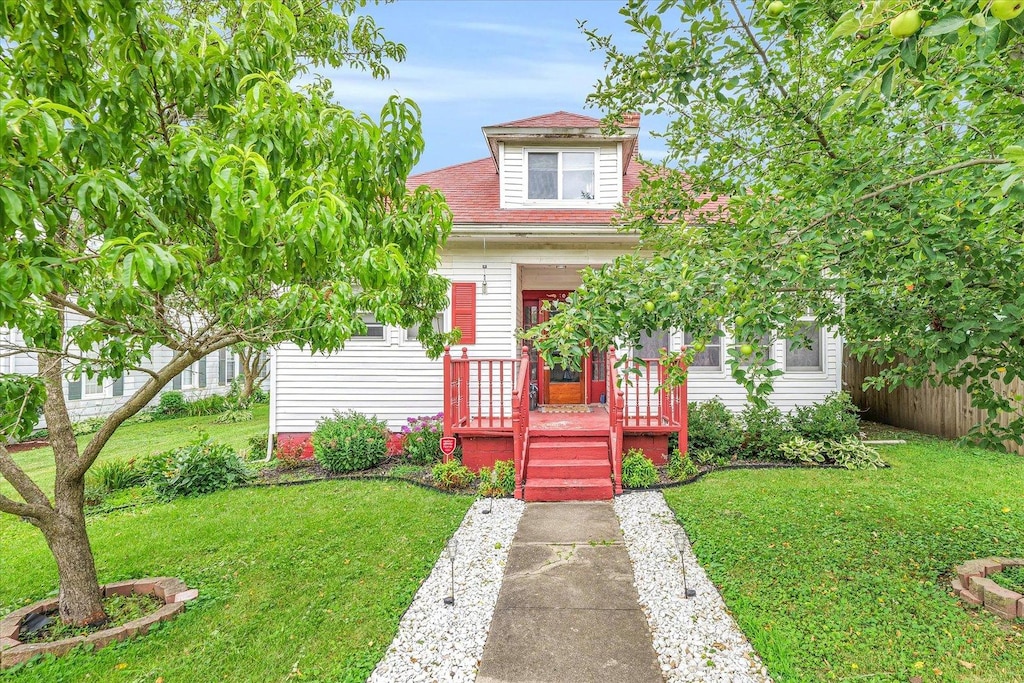 bungalow-style home with a front yard