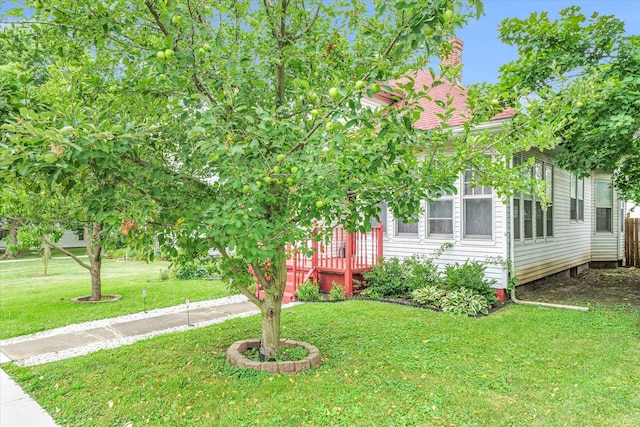 obstructed view of property with a wooden deck and a front yard