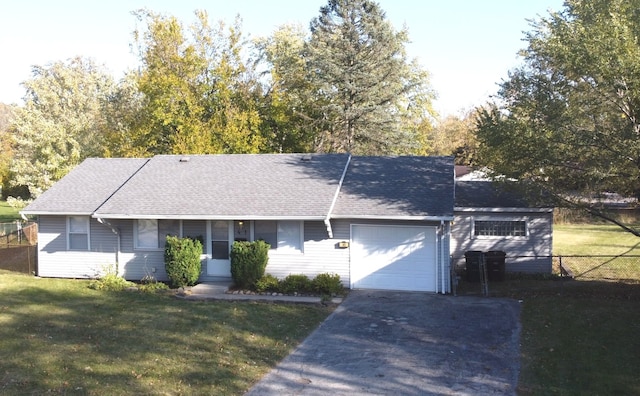 ranch-style house with a garage and a front lawn