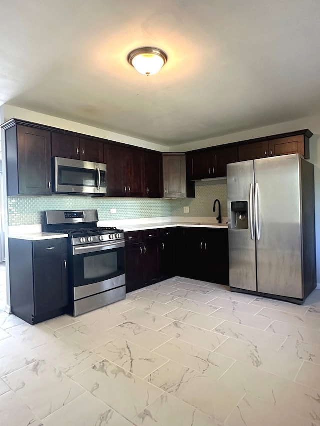 kitchen featuring light tile patterned floors, dark brown cabinets, tasteful backsplash, and stainless steel appliances