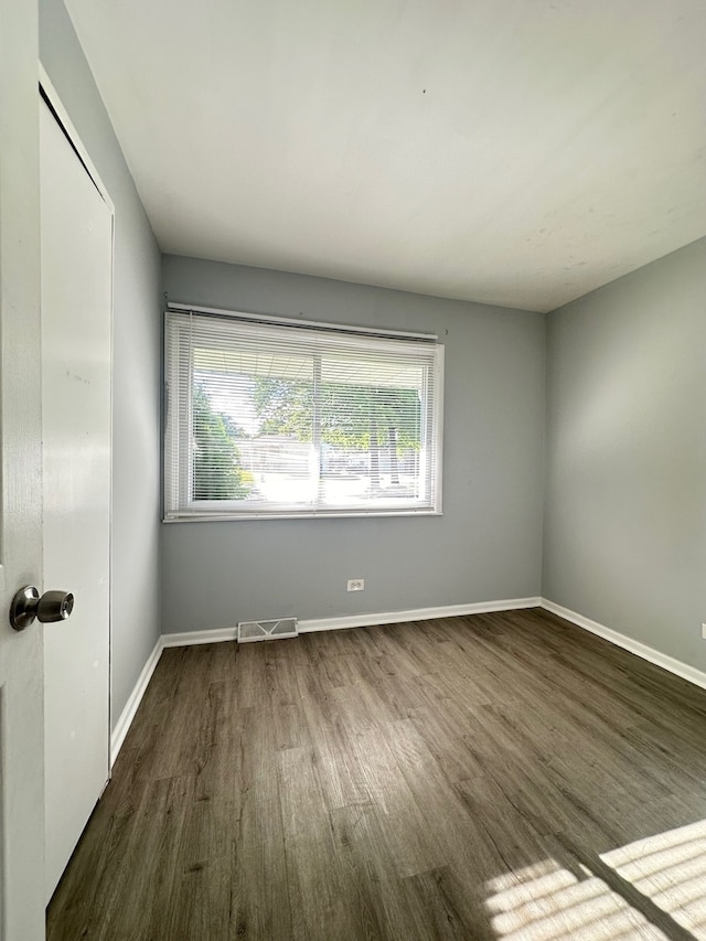 unfurnished room featuring dark hardwood / wood-style floors