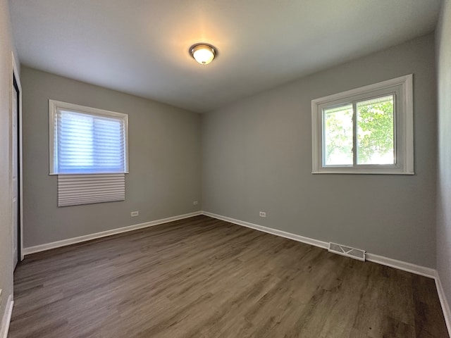 spare room featuring dark hardwood / wood-style flooring