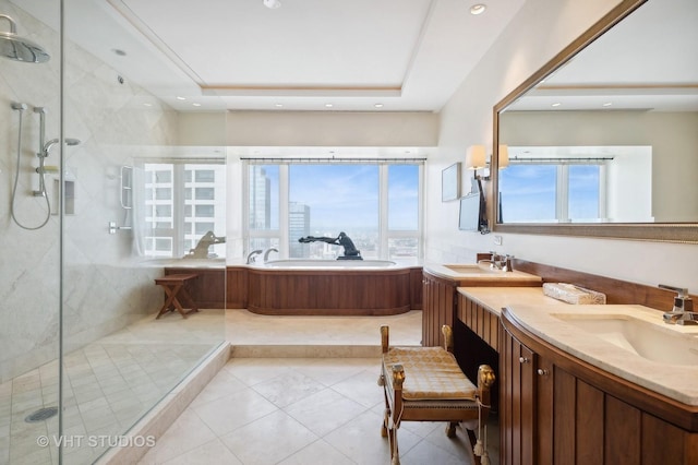 bathroom featuring a raised ceiling, tile patterned flooring, vanity, and independent shower and bath