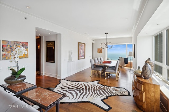 dining room featuring dark hardwood / wood-style flooring, an inviting chandelier, and crown molding