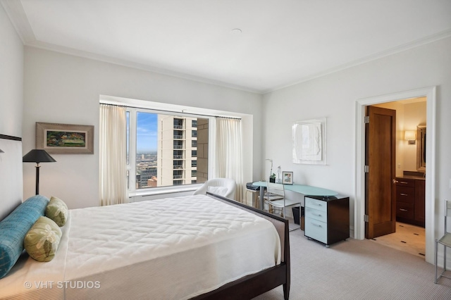 carpeted bedroom with ensuite bathroom and crown molding