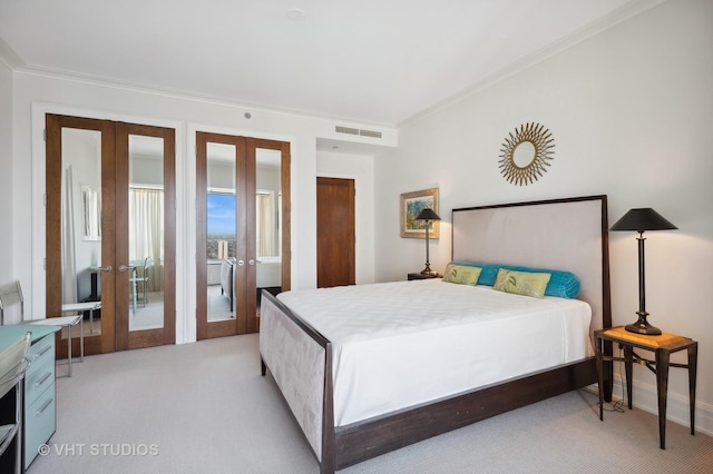 carpeted bedroom featuring french doors and ornamental molding