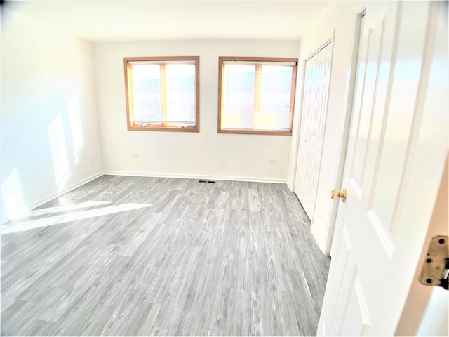 unfurnished room with light hardwood / wood-style floors