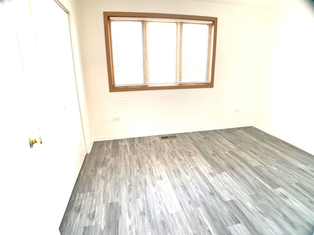 spare room with dark wood-type flooring