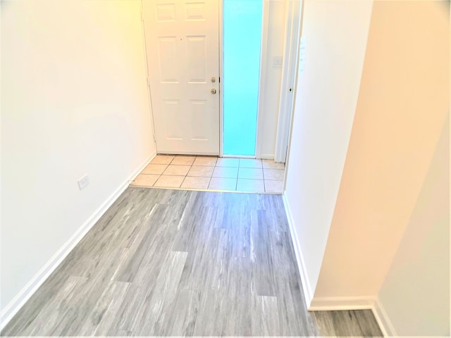 hall featuring light tile patterned flooring