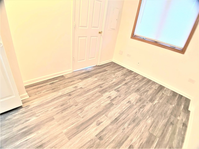 spare room with hardwood / wood-style floors