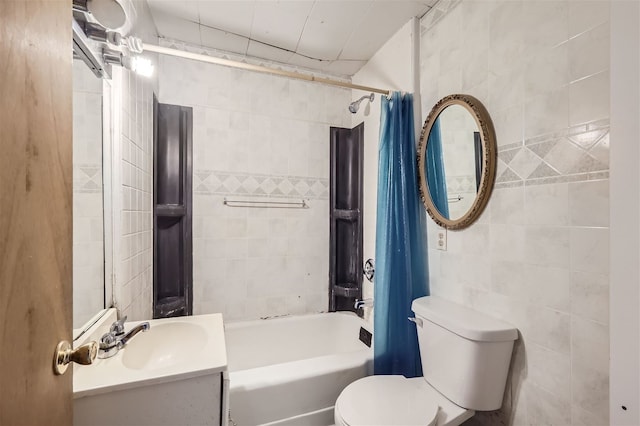 full bathroom featuring vanity, shower / bathtub combination with curtain, tile walls, and toilet